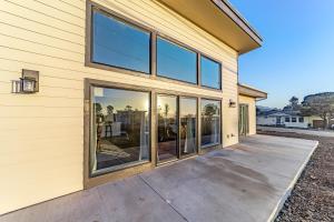 a house with large glass windows on the side of it at Pacific Breeze in Gold Beach