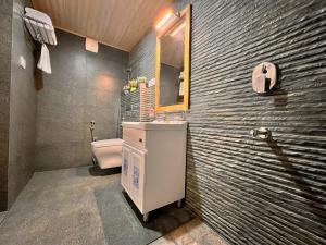 a bathroom with a sink and a toilet at Jomotel Talai in Cheog +87 photos