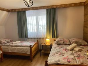 Posteľ alebo postele v izbe v ubytovaní Willa Dziubas z jacuzzi & sauną