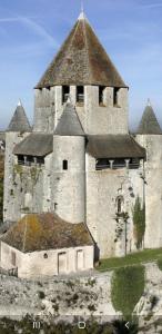 an old building with a tower on top of it at Calme Studio & WIFI Jardin Disneyland Paris 4 personnes in Faremoutiers