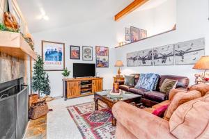 a living room with a couch and a tv at Ski Alta in Sandy