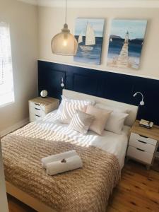 a bedroom with a large bed with a blue headboard at 19 Malachite Mews in Knysna