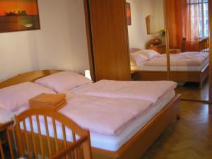 2 Einzelbetten in einem Zimmer mit Spiegel in der Unterkunft Holiday Apartment up to 7 in Bratislava