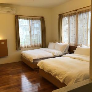 Postel nebo postele na pokoji v ubytování Qiao Kela Ti Homestay