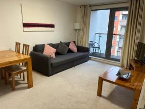 a living room with a couch and a table at Apartments at Granville in Birmingham