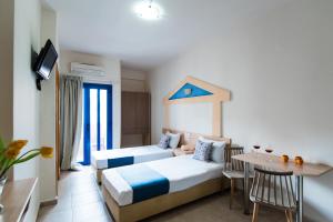 Ilios Malia Hotel Resort客房内的一张或多张床位