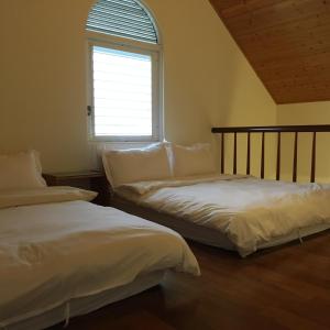 Postel nebo postele na pokoji v ubytování Qiao Kela Ti Homestay