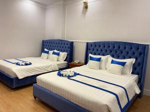 Letto o letti in una camera di Peach Valley Hotel Dalat