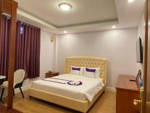 Letto o letti in una camera di Peach Valley Hotel Dalat