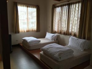 Postel nebo postele na pokoji v ubytování Qiao Kela Ti Homestay