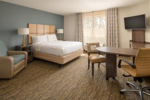 a hotel room with a bed and a desk at Candlewood Suites Vancouver/Camas by IHG in Vancouver