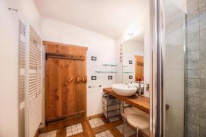 a bathroom with a sink and a mirror at La pratolina monolocale in Castello di Fiemme +9 photos