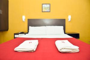 a bedroom with a bed with two towels on it at Balaji Lodge in Villupuram +38 photos