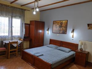 A bed or beds in a room at Alexandros Guesthouse