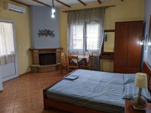 A bed or beds in a room at Alexandros Guesthouse