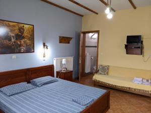 A bed or beds in a room at Alexandros Guesthouse