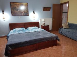 A bed or beds in a room at Alexandros Guesthouse