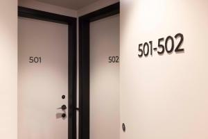 two doors with numbers on them next to each other at Le 12 Hôtel in Paris