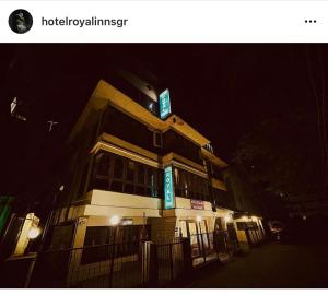a building with a sign on top of it at night at Hotel Royal inn and restaurant in Srinagar