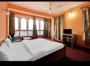 a bedroom with a large bed and a window at Hotel Royal inn and restaurant in Srinagar