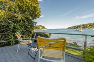 two chairs sitting on a deck overlooking the water at Dockside Guest Quarters in York