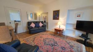 a living room with a couch and a television at 51 Milton Crescent, Anstruther in Anstruther