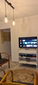 a living room with a flat screen tv on a wall at Carlos Paz - 3 Dormitorios con cochera - Zona céntrica residencial in Villa Carlos Paz