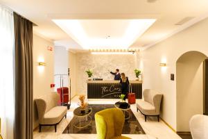 a man standing in front of a stage in a lobby at The Cross Hotel in Rome