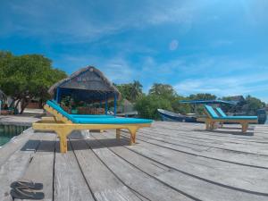 two slides on a wooden deck with a playground at Eco hotel los erizos in Isla Grande