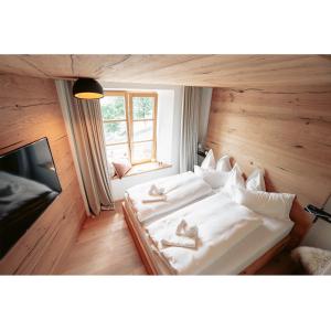 a bedroom with two beds with slippers on them at Mesnerhaus & Gourmetrestaurant Mesnerhaus mit 4 Hauben in Mauterndorf