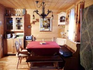 un comedor con una mesa roja en una habitación en Haus Andreas - Chalet 306, en Turracher Höhe