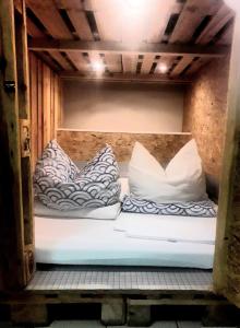 a bunk bed with two pillows on it at FOX BOX I Capsule Apt in Dresden