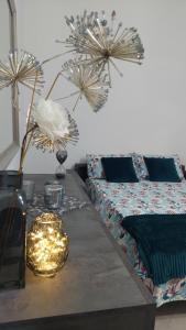 a living room with a table with a bed and flowers at Sweet Home in Lido di Ostia