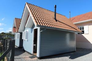 a garage with a brown roof on a house at Chalés Poncho Serrano in Gramado