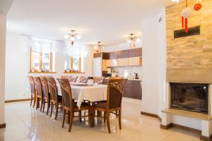 a dining room with a table and chairs and a fireplace at Dzika Róża in Szklarska Poręba