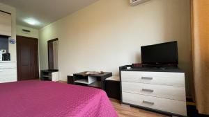 A television and/or entertainment centre at SUMMER BREEZE 406 Studio Sunny Beach