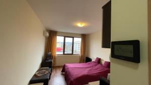 A television and/or entertainment centre at SUMMER BREEZE 406 Studio Sunny Beach