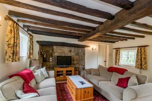 a living room with two couches and a tv at Captivating 6 Bed Cottage in the village of Moulso in Newport Pagnell