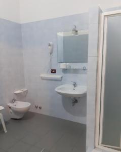 a white bathroom with a sink and a toilet at Da Santo Hotel Ristorante Pizzeria in Ferrara