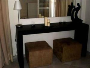 a black desk with a mirror and a stool at Diavlos Studios in Agiokampos +22 photos