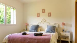 a bedroom with a large bed with a purple blanket at "Le Cottage" Appartements avec SPA privatif in Saint-Bonnet-en-Champsaur