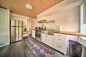 a kitchen with white cabinets and stainless steel appliances at Historic Family Home 2 Mi to Lake Erie and Zoo! in Erie