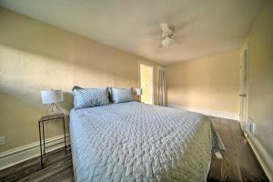 a bedroom with a bed and a ceiling fan at Historic Family Home 2 Mi to Lake Erie and Zoo! in Erie