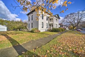 a white house on a street with leaves on the grass at Historic Family Home 2 Mi to Lake Erie and Zoo! in Erie