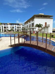 a bridge over a pool in front of a building at Boas Vistas Canoa Quebrada in Aracati