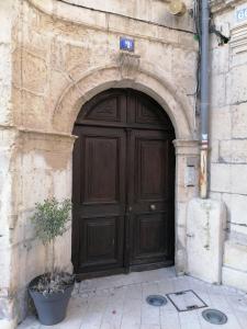 a large wooden door in a stone building at Les Tiercelines in Dole