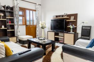 a living room with a couch and a tv at Vila Palma in Berat