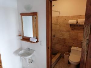 a bathroom with a toilet and a sink at Vista Encantada in Villa Canales