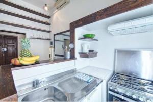 a kitchen with a sink and a stove at Piazza di Spagna Heart Of Rome Best LocatioN in Rome