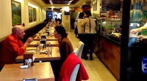 a man and woman sitting at tables in a restaurant at Hotel Mara İstanbul in Istanbul